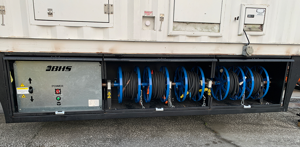 reel winder installed under a trailer to provide mobile power restoration